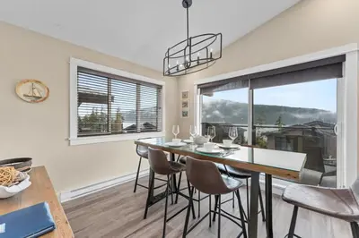 a dining room with a table and chairs and a window at Wild Beauty - Oceanview - Pet Friendly - sleep 2 in Port Renfrew