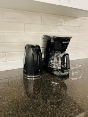 a black coffee maker sitting on top of a counter at Modern Comfort in NW Calgary in Calgary
