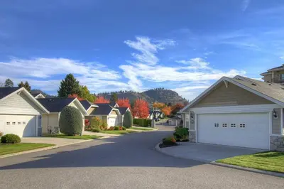 a residential neighborhood with houses and a driveway at Queen bedroom suite with private bathroom and independent entrance in Kelowna