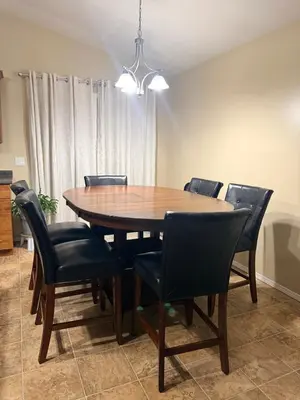a dining room table and chairs in a room at Gans Home - 5 Bedroom Residence in Lloydminster