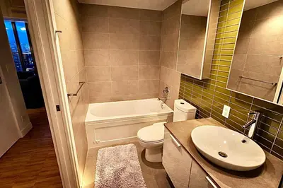 a bathroom with a white toilet and a sink at Pacific Pearl in Vancouver