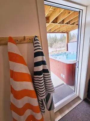 two towels hanging on a wall next to a sliding glass door at Ultimate Family Retreat Beach, Hot Tub & Games in Windermere