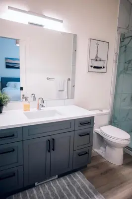 a bathroom with a sink and a toilet and a mirror at Ultimate Family Retreat Beach, Hot Tub & Games in Windermere