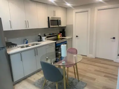a small kitchen with a glass table and chairs at Beautiful one Bedroom Bsmnt suite with sep Entrance in Edmonton