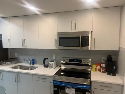 a kitchen with a microwave and a stove top oven at Beautiful one Bedroom Bsmnt suite with sep Entrance in Edmonton