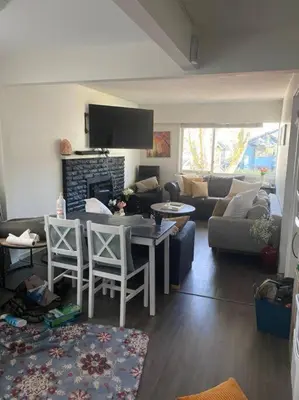 a living room with a couch and a table and chairs at Quiet-comfy 4 bedroom house on a tree lined street in Kitsilano in Vancouver