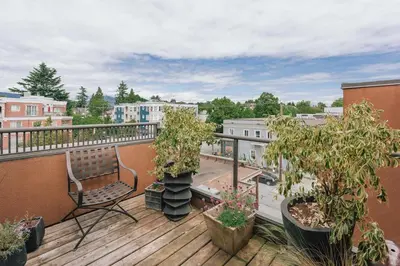 a balcony with a bench and potted trees on it at Private Penthouse Beside Beach with Rooftop Patio in Vancouver