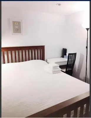 a bedroom with a bed and a desk and a chair at Dunbar Home in Vancouver