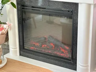 a fireplace in a living room with flames in it at Beach House in Vancouver