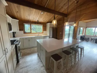 a large kitchen with a large island in a house at Lakeview Mountain Retreat - Private, Modern, Fun in Windermere
