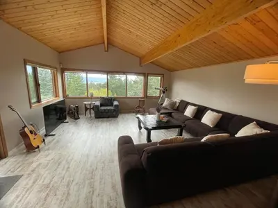 a living room with a couch and a guitar at Lakeview Mountain Retreat - Private, Modern, Fun in Windermere
