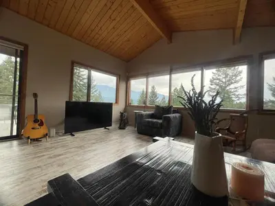 a living room with a television and a guitar at Lakeview Mountain Retreat - Private, Modern, Fun in Windermere
