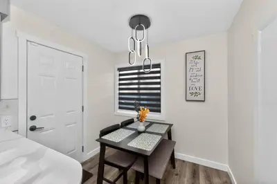 a dining room with a table and a window at NEW 2BR Near Downtown Calgary - Private Entry - Airport Access - 4412 UP in Calgary