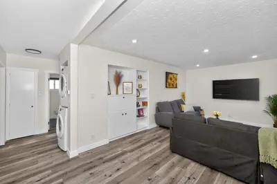 a living room with a couch and a tv at NEW 2BR Near Downtown Calgary - Private Entry - Airport Access - 4412 UP in Calgary