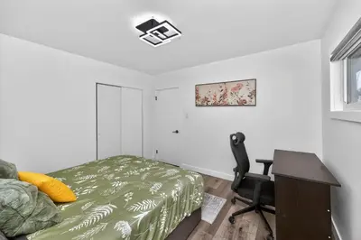 a bedroom with a bed and a desk and a chair at NEW 2BR Near Downtown Calgary - Private Entry - Airport Access - 4412 UP in Calgary