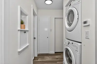 a white laundry room with a washer and dryer at NEW 2BR Near Downtown Calgary - Private Entry - Airport Access - 4412 UP in Calgary