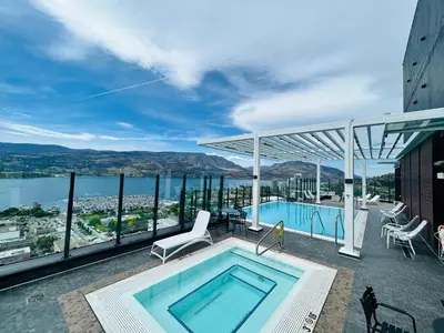 a pool on a building with a view of the water at Signature Iconic Lakeview Downtown 2-Bedroom Loft in Kelowna