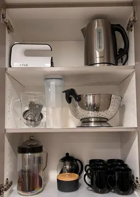 a kitchen shelf with a tea kettle and other kitchen items at Signature Iconic Lakeview Downtown 2-Bedroom Loft in Kelowna