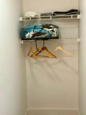 a closet with shelves and a bag at Cozy 1-Bed Basement Suite in Calgary