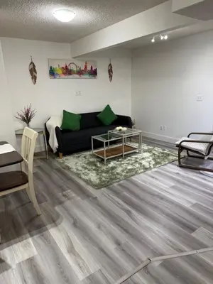 a living room with a couch and a table at Cozy 1-Bed Basement Suite in Calgary
