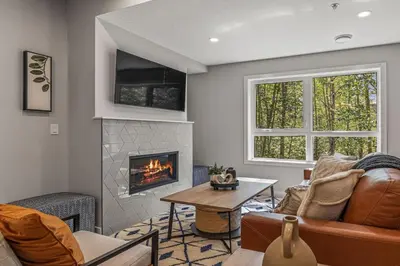 a living room with a couch and a fireplace at 3BR Canmore Haven w/ BBQ and free parking in Canmore