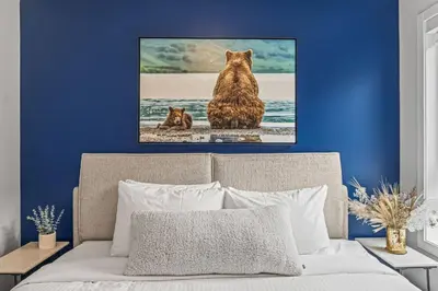 two cats sitting on the beach in front of the ocean at 3BR Canmore Haven w/ BBQ and free parking in Canmore