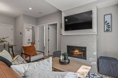 a living room with a couch and a fireplace at 3BR Canmore Haven w/ BBQ and free parking in Canmore