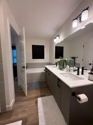 a bathroom with two sinks and a bath tub at Fort Home in Fort Saskatchewan