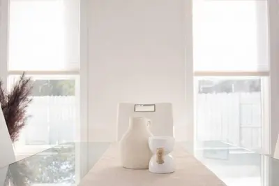 two white vases sitting on a table in a room at 4-Level Split Home in Southeast Edmonton in Edmonton