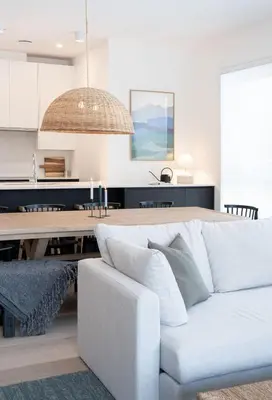 a living room with a white couch and a table at Powder and Par Penthouse by Revelstoke Vacations in Revelstoke