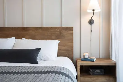 a bedroom with a bed and a table with a lamp at Powder and Par Penthouse by Revelstoke Vacations in Revelstoke