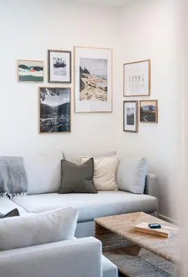 a living room with a couch and pictures on the wall at Powder and Par Penthouse by Revelstoke Vacations in Revelstoke