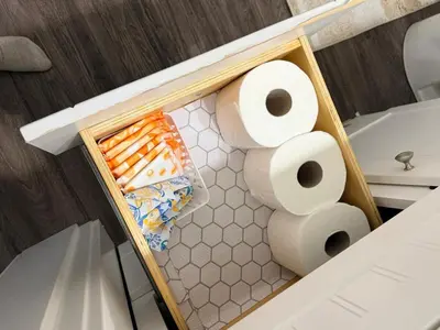 a box of rolls of toilet paper in a bathroom at Stylish Open Cozy & Contemporary Living Space in Prince George