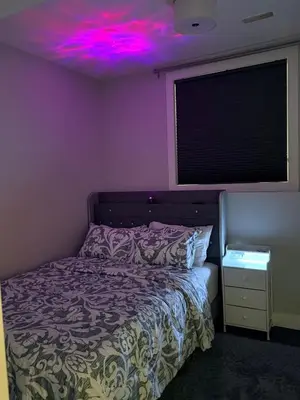 a bedroom with a bed with a purple ceiling at Stylish Open Cozy & Contemporary Living Space in Prince George