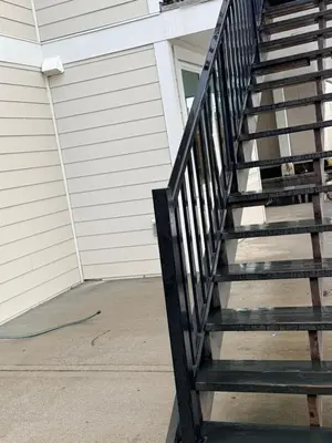 a black staircase in front of a house at Stylish Open Cozy & Contemporary Living Space in Prince George