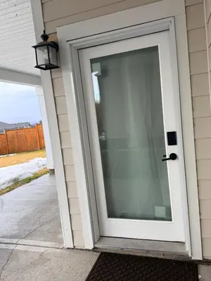 a sliding glass door on a house at Stylish Open Cozy & Contemporary Living Space in Prince George