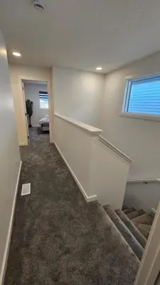 an empty hallway with stairs in a house at 3 Bedroom Modern Luxury House - Family Friendly, 3 Queen Beds, Free Wi-Fi, and Free Parking in Calgary