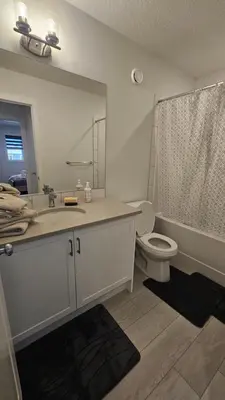 a bathroom with a sink and a toilet and a shower at 3 Bedroom Modern Luxury House - Family Friendly, 3 Queen Beds, Free Wi-Fi, and Free Parking in Calgary