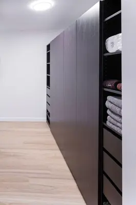 a walk in closet with a stainless steel refrigerator at Modern 3Bed Home with Fireplace, Game Room, and Stylish Comfort Just 12 Minutes from Downtown Calgary in Calgary
