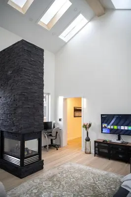 a living room with a fireplace and a tv at Modern 3Bed Home with Fireplace, Game Room, and Stylish Comfort Just 12 Minutes from Downtown Calgary in Calgary