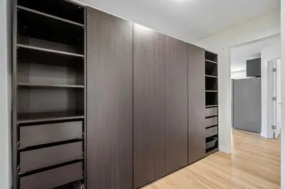 a large closet with wooden shelves in a room at Modern 3Bed Home with Fireplace, Game Room, and Stylish Comfort Just 12 Minutes from Downtown Calgary in Calgary