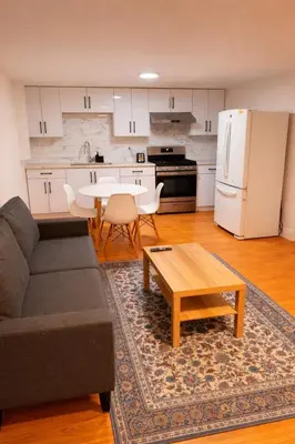 a living room with a couch and a table and a kitchen at Amalak Homes' Private 2BR Guest Suite North Delta in Delta