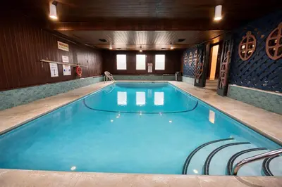 a large swimming pool with chairs in a room at Rychter Hotel Hope in Hope