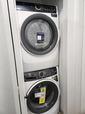 a washing machine and a dryer in a room at The Rupert Split Flexible Family Living in Vancouver