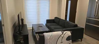 a living room with a couch and a coffee table at UBC Area Gem Spacious 2-Bedroom Townhouse with Full Kitchen in Vancouver