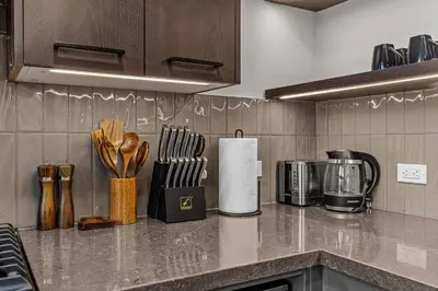 a kitchen counter with utensils on a counter top at Penthouse Loft| 2BD| Mountain Views| Pool + HotTub in Canmore