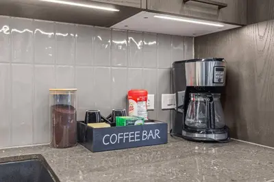 a coffee bar on a counter in a kitchen at Premier Suite | Mountain Views | Sleeps 10 in Canmore