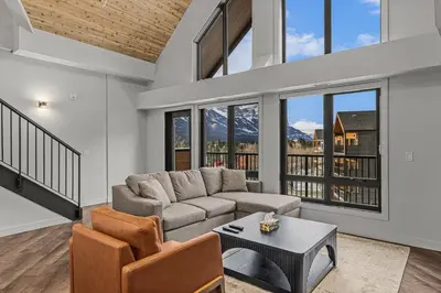 a living room with a couch and a table at Premier Suite & Penthouse Loft - Sleeps 16 in Canmore