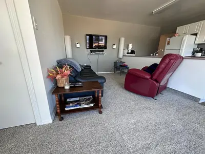 a living room with a couch and a table at Texada Hunter Hiker friendly suite in Vananda