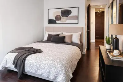 a bedroom with a large bed in a room at Elegant 2-Bedroom Condo in Vibrant Yaletown District in Vancouver
